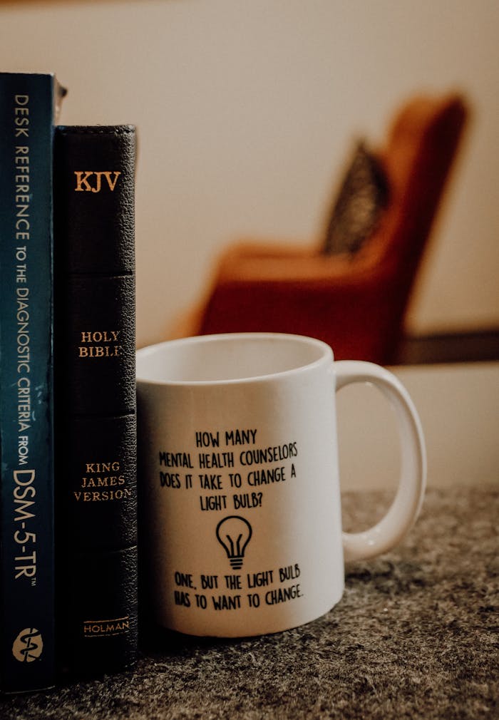 A cozy scene with books and a humorous coffee mug in Baltimore, MD.